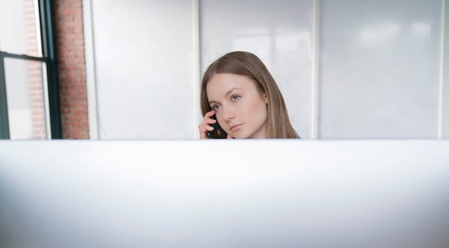 Working at a desk Image of a woman working infront of a computer screen