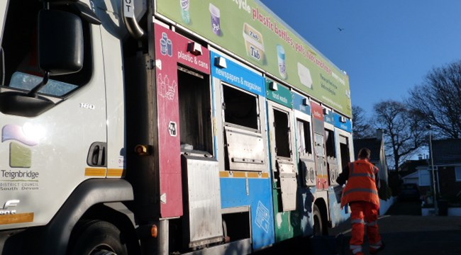 Staff member beside recycling collection vehicle